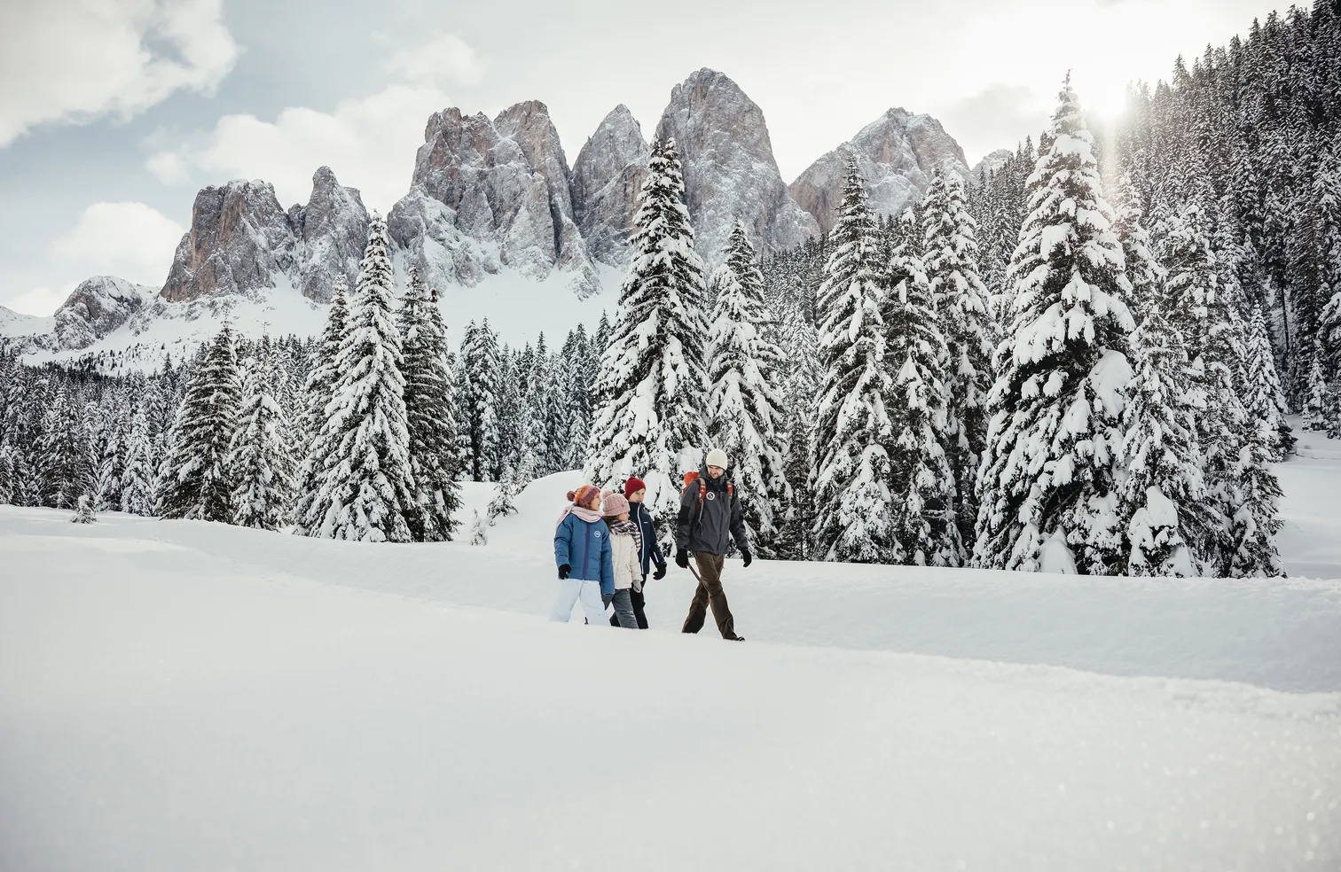 Winter hiking on the snow-covered Luson Alp with panoramic view of Peitlerkofel and Geisler group