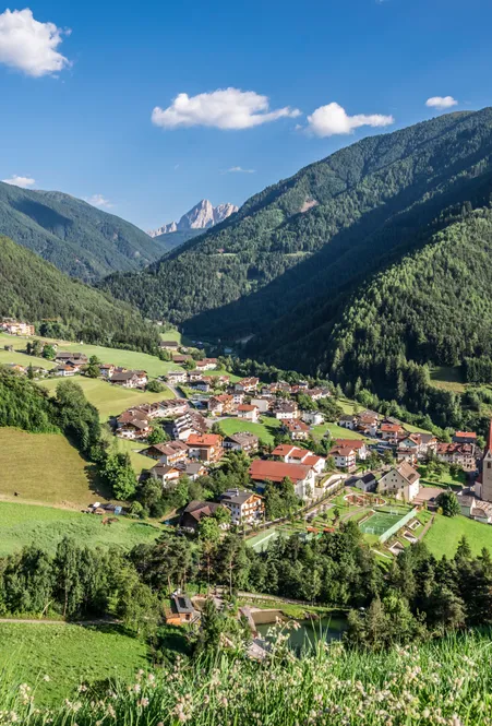 Hamlet Village in Luson in summer with parish church