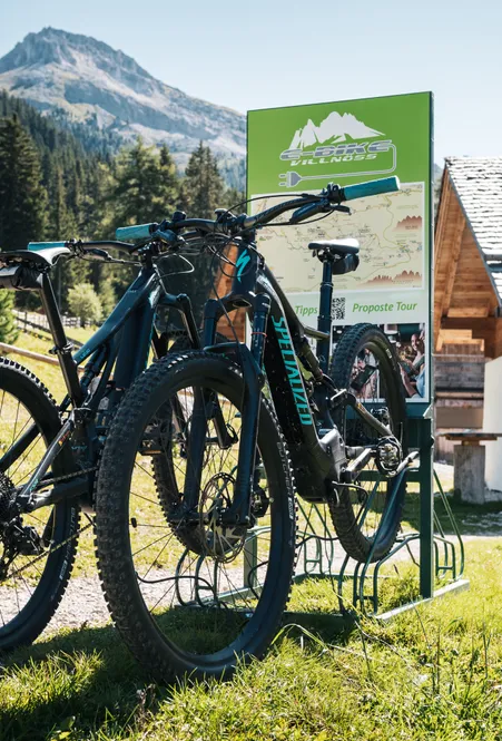 E-Bike Villnöß Ladestation mit Specialized E-Bikes vor traditioneller Almhütte mit Peitlerkofel-Blick