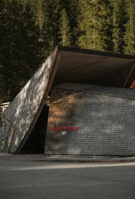 Modern infopoint building with shingle-clad facade in Puez-Geisler Nature Park Villnöß
