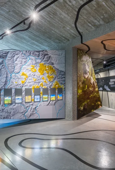 Interactive exhibition in Puez-Geisler Nature Park visitor center with relief map geological information panels and installations
