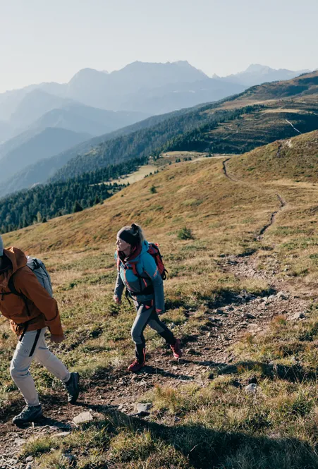 Hiker on Luson Alp with mountain panorama – idyllic alpine landscape and extensive hiking trails in South Tyrol
